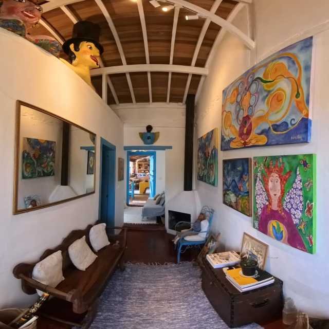 Colorful gallery hall inside Natasha Faria's atelier, with original paintings displayed on the walls